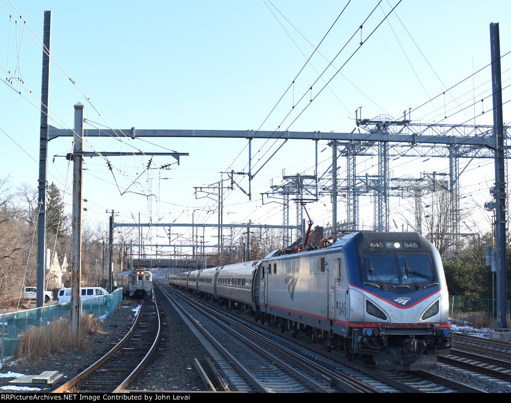 ACS-64 # 645 leads Amtrak Northeast Regional Train # 153 while the first westbound Princeton Dinky of the day proceeds to its platform at PJC 